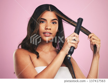 Portrait, woman and hair care with iron for studio beauty, cosmetic treatment or shine on pink background. Face of model, hairstyle or heating equipment of electric tools for smooth aesthetic texture Portrait, woman and hair care with iron for studio beauty, cosmetic treatment or shine on pink background. Face of model, hairstyle or heating equipment of electric tools for smooth aesthetic texture 137417563