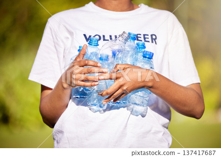 Volunteer hands, plastic bottle and park for community service, recycling and climate change or earth day project. Person volunteering outdoor or nature for eco friendly cleaning or nonprofit support Volunteer hands, plastic bottle and park for community service, recycling and climate change or earth day project. Person volunteering outdoor or nature for eco friendly cleaning or nonprofit support 137417687