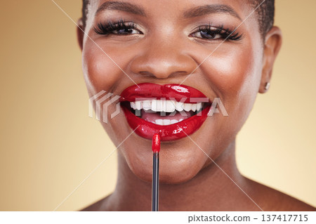 Makeup brush, beauty and a woman with red lipstick in studio for closeup, glow or cosmetics. Face of happy African person with facial shine, dermatology and application on mouth on a beige background Makeup brush, beauty and a woman with red lipstick in studio for closeup, glow or cosmetics. Face of happy African person with facial shine, dermatology and application on mouth on a beige background 137417715