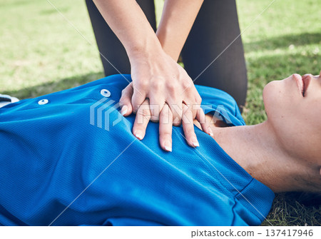 CPR, lung press and woman hands on field for sport, fitness and game with accident and emergency. Training, paramedic and medical help for breathe from injury with first aid and athlete outdoor CPR, lung press and woman hands on field for sport, fitness and game with accident and emergency. Training, paramedic and medical help for breathe from injury with first aid and athlete outdoor 137417946