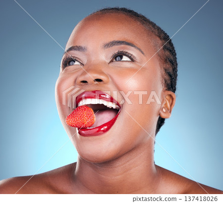 Skincare, strawberry and black woman with beauty, health and wellness on a blue studio background. Person, fruit and model with cosmetics, diet and nutrition with grooming, aesthetic and dermatology 137418026