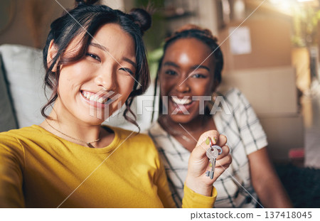 Couple of friends, keys and new home selfie for moving in together for real estate investment. Rent, mortgage and loan of women with smile for social media portrait at apartment or house with partner 137418045