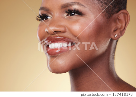 Beauty, makeup and face of a happy black woman in studio for self care, skincare and cosmetics. Closeup of African aesthetic model person with facial shine, teeth smile and glow on a beige background Beauty, makeup and face of a happy black woman in studio for self care, skincare and cosmetics. Closeup of African aesthetic model person with facial shine, teeth smile and glow on a beige background 137418173