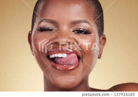 Wink, lick lips and beauty of a woman in studio for skin care, makeup and cosmetics. Face of a happy african model person with facial shine, dermatology and wellness or flirting on a beige background Wink, lick lips and beauty of a woman in studio for skin care, makeup and cosmetics. Face of a happy african model person with facial shine, dermatology and wellness or flirting on a beige background 137418185