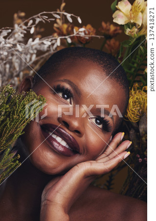 Beauty, cosmetic and black woman with flowers in a studio for natural face makeup for cosmetology. Happy, smile and young African female model with floral aesthetic isolated by a brown background. Beauty, cosmetic and black woman with flowers in a studio for natural face makeup for cosmetology. Happy, smile and young African female model with floral aesthetic isolated by a brown background. 137418271