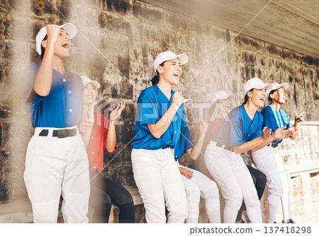 Sports, baseball player or excited team celebrate teamwork, achievement and cheers for homerun. Group, dugout row or happy women clapping for match competition success, winner praise or club victory Sports, baseball player or excited team celebrate teamwork, achievement and cheers for homerun. Group, dugout row or happy women clapping for match competition success, winner praise or club victory 137418298