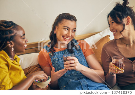 Group of women, friends on sofa with drinks and smile, bonding in living room together in lounge. Happiness, love and friendship, girls on couch with diversity, pride and cocktail in home with fun. Group of women, friends on sofa with drinks and smile, bonding in living room together in lounge. Happiness, love and friendship, girls on couch with diversity, pride and cocktail in home with fun. 137418370