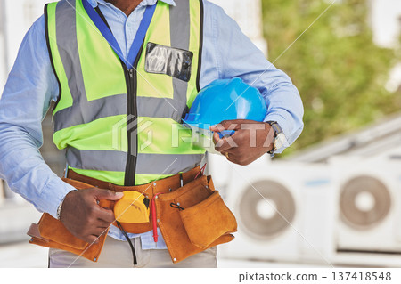 Man, helmet closeup or engineer on construction site for maintenance or architecture outdoor. Body of contractor, professional renovation or handyman building urban infrastructure with tools on waist 137418548