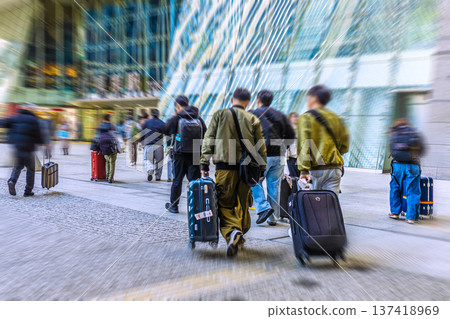Tokyo cityscape in Japan: Suitcases... Inbound tourism continues... Foreign tourists moving around in front of Tokyo Station (Nihonbashi Exit)... 137418969