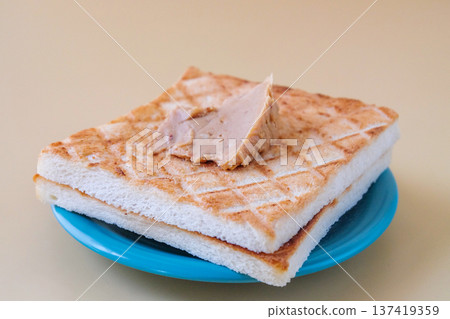 Delicious sandwich with peanut butter on top. 137419359