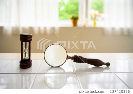 Hourglass and magnifying glass 137420356