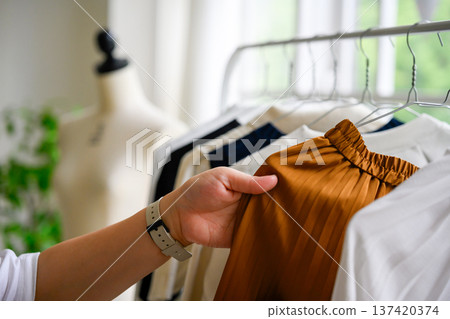 Choosing clothes in the closet Choosing clothes in the closet 137420374
