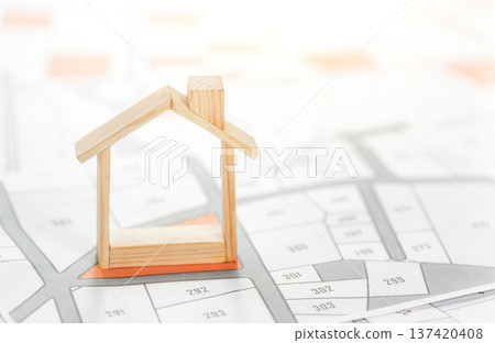 The house is placed on the land map. choose the land location building plot for house construction. real estate concept with vacant land for building construction for sale, rent, buy, investment. 137420408