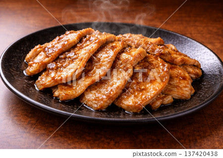 Shiny pork ginger fried on a black plate 137420438