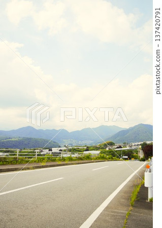 A view of the mountains, cloudy sky, and highway from Katsunuma Hill in early summer (Koshu City, Yamanashi Prefecture) A view of the mountains, cloudy sky, and highway from Katsunuma Hill in early summer (Koshu City, Yamanashi Prefecture) 137420791
