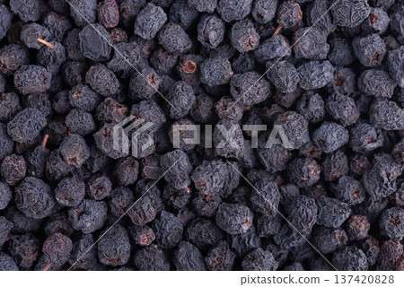 Dried aronia berries background. Dry black chokeberry. Top view. Dried aronia berries background. Dry black chokeberry. Top view. 137420828