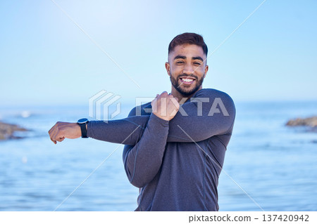 Beach portrait, exercise and happy man stretching arm for outdoor freedom, sports workout or start routine. Blue sky, natural sea water and Indian person doing relax training warm up on nature island Beach portrait, exercise and happy man stretching arm for outdoor freedom, sports workout or start routine. Blue sky, natural sea water and Indian person doing relax training warm up on nature island 137420942