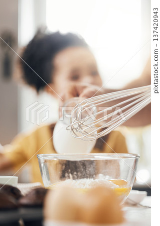 Whisk, egg and kitchen in closeup, kid and learning with muffins, cooking and helping hand from parents. Bowl, flour and child with development, teaching and baking with milk, cupcakes or family home 137420943