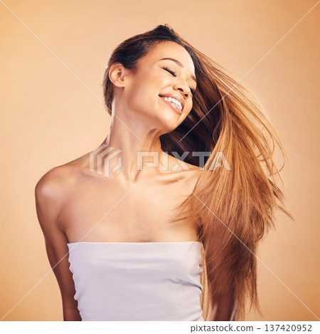 Smile, beauty and hair with a natural woman in studio on a brown background for keratin treatment. Freedom, shampoo and wind with a happy young model at the salon for growth or aesthetic haircare Smile, beauty and hair with a natural woman in studio on a brown background for keratin treatment. Freedom, shampoo and wind with a happy young model at the salon for growth or aesthetic haircare 137420952