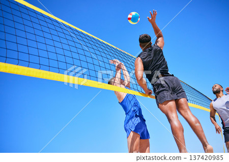Beach volleyball match, blue sky and sports team jump, playing competition and practice for tournament challenge. Below view, athlete action and people in air workout, training or nature exercise 137420985