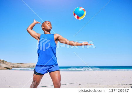 Beach volleyball, sports and black man serve ball, play competition and athlete training in outdoor challenge. Blue sky, freedom and African player workout, exercise and start game, match or practice Beach volleyball, sports and black man serve ball, play competition and athlete training in outdoor challenge. Blue sky, freedom and African player workout, exercise and start game, match or practice 137420987
