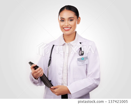 Happy woman, doctor and portrait with tablet in healthcare research or online advice against a studio background. Female person or medical professional smile with technology for Telehealth on mockup 137421005
