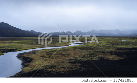 River streaming through harsh Nordic volcanic landscape with cloudy sky, Highlands Iceland River streaming through harsh Nordic volcanic landscape with cloudy sky, Highlands Iceland 137421093