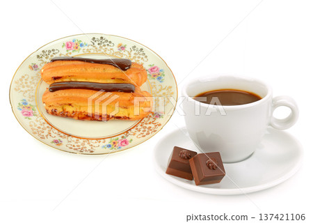 Sweet Breakfast Concept with Chocolate Eclairs and Black Coffee Sweet Breakfast Concept with Chocolate Eclairs and Black Coffee 137421106