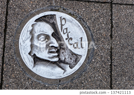 France, Clermont Ferrand, a nail bearing the likeness of Blaise Pascal marking a tourist route in the city. France, Clermont Ferrand, a nail bearing the likeness of Blaise Pascal marking a tourist route in the city. 137421113