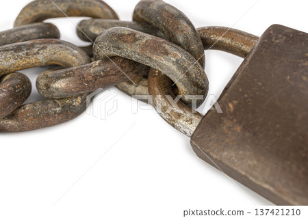 Close-Up of an Old, Weathered Metal Chain Attached to a Rusty Padlock on a White Background Symbolizes Strength and Security Close-Up of an Old, Weathered Metal Chain Attached to a Rusty Padlock on a White Background Symbolizes Strength and Security 137421210