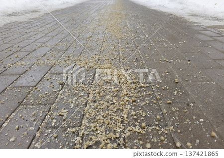 The slippery road is sprinkled with technical salt The slippery road is sprinkled with technical salt 137421865
