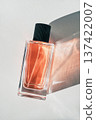Perfume bottle showcasing fragrance and elegance with abstract light and shadow patterns 137422007