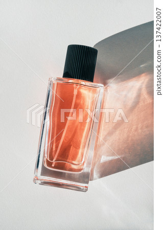 Perfume bottle showcasing fragrance and elegance with abstract light and shadow patterns 137422007