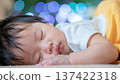 Portrait of a cute baby taking a nap 137422318