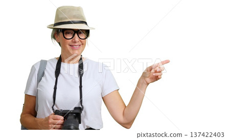 Woman tourist with camera pointing finger to side 137422403