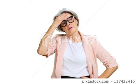 Senior woman experiencing headache, stress, and fatigue on white background 137422410
