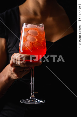 alcoholic red cocktail in hands 137422561