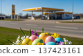 Easter eggs flowers by roadside gasstation, spring pastel travel holiday scene with copyspace for seasonal service ads 137423161