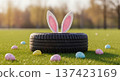 Tire Easter bunny ears eggs on grass, spring auto service holiday concept outdoors with pastel decorations and copyspace 137423169