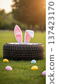 Tire Easter bunny ears eggs on grass, spring auto service holiday concept outdoors with pastel decorations and copyspace 137423170