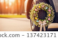 Tire easter wreath flowers eggs on car wheel, spring holiday decoration on vehicle outdoors with copy space for sale ads 137423171
