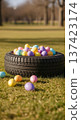 Tire Easter eggs grass spring pastel auto service holiday outdoors display in park, seasonal car care promotion concepts 137423174