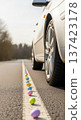 Car wheel road Easter eggs spring auto travel concept on asphalt lane, seasonal transport holiday scene with copy space. 137423178