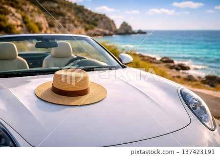 Roadtrip convertible car beach coastline sea vacation travel summer hat scene with white cabriolet on a coastal road, warm sunlight, blue water and cliffs, ideal for luxury getaway and tourism ads. 137423191