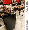 Shelves filled with casual and formal shoes in a retail shop. Stylish designs and contemporary shopping vibe. 137424302
