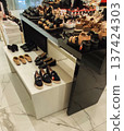Shelves filled with casual and formal shoes in a retail shop. Stylish designs and contemporary shopping vibe. 137424303