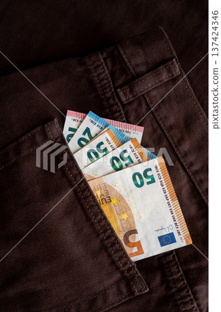 Jeans with paper euro money for shopping. Cash bills in the pants pocket for commerce concept. Jeans with paper euro money for shopping. Cash bills in the pants pocket for commerce concept. 137424346
