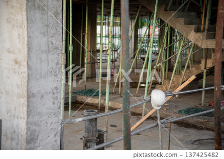 Image of a white work helmet with construction and work area background Image of a white work helmet with construction and work area background 137425482