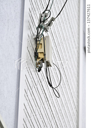 Internet, fiber optic lines, and telephones: Construction on the exterior walls of homes 137427611