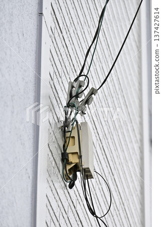 Internet, fiber optic lines, and telephones: Construction on the exterior walls of homes 137427614
